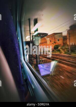 Looking out the window of a train on it's way into Paddington. You can see reflections from inside the carriage in the window. Stock Photo