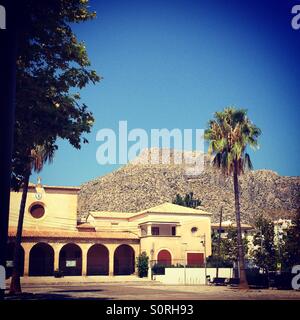 Puerto Pollensa, Mallorca, church square and Tramuntana mountains Stock Photo