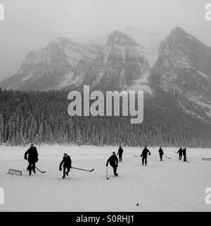 You know you're in Canada when you stumble onto an impromptu January hockey game on Lake Louise Stock Photo