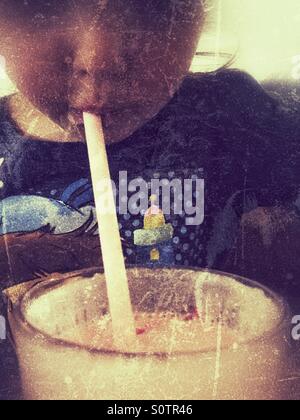 Drinking through a straw Stock Photo