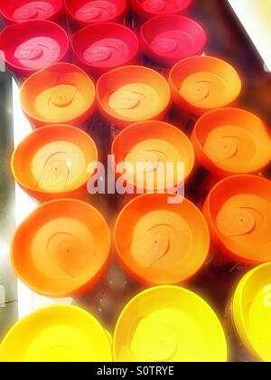 Close-up of multicolored travel mug lids shot from above Stock Photo