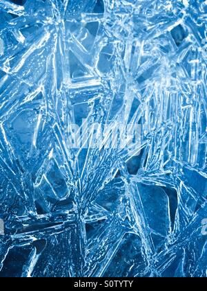 Close up of the crystal formations of water frozen over a creek. Stock Photo