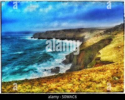 A Landscape View from Land's End looking North towards Sennen Cove in Cornwall, England. The wild Atlantic Ocean is pounding the coastline. Photo Credit © COLIN HOSKINS. Stock Photo