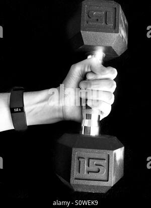 Fitness tracker and dumbbell Stock Photo