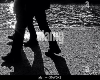 Shadow and silhouette of people walking on the city street sidewalk ...