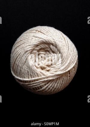 Ball of string on black background Stock Photo