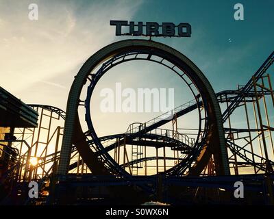 Turbo roller coaster on Brighton pier at sunset Stock Photo