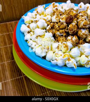 Popcorn and caramel corn close-up in blue, red green bowl Stock Photo