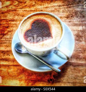 Heart motif in a cup of coffee. Stock Photo