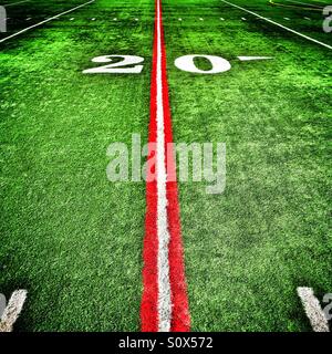 Twenty yard line painted red on an American football field Stock Photo