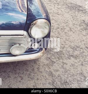 Close up to lights of old car Mini Cooper vintage blue color Stock Photo