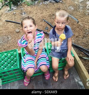 Little girl and little boy eating ice cream Stock Photo