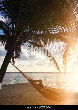 Man in a hammock, South Water Caye , Belize Stock Photo