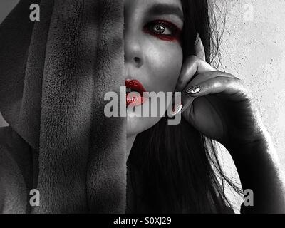 Artistic self portrait, hooded woman red makeup Stock Photo