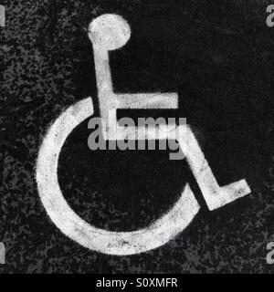 Handicapped sign painted on the road in black and white colors Stock Photo