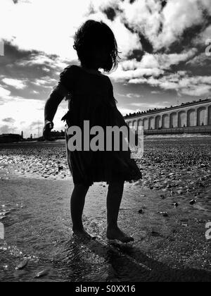 Silhouette of young girl on beach