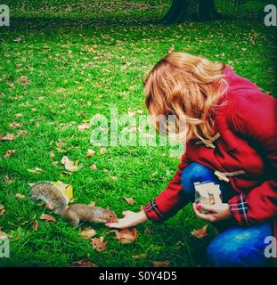Feeding the squirrel in Hyde Park, London Stock Photo