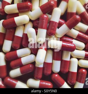 Red and white medicine capsules Stock Photo