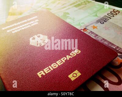 A German passport on 500 and 100 Euro bills Stock Photo