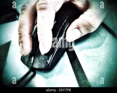 A man's hand using a computer mouse. Stock Photo