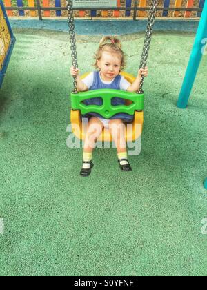 Toddler on the swing Stock Photo