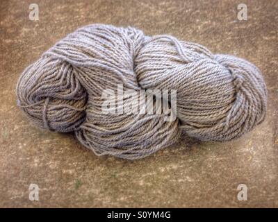 Yarn balls neatly arranged on a surface, showcasing their textured craftsmanship and natural fibers Stock Photo