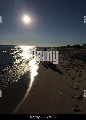 Sunset walk on the beach. Stock Photo