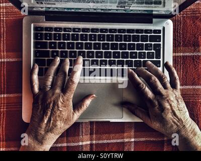 Old woman using laptop Stock Photo