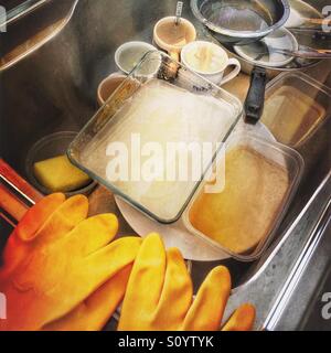 Kitchen sink full of dirty dishes Stock Photo