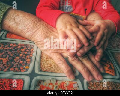 Grandmother and baby hands Stock Photo
