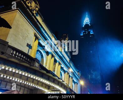 Grand Central Station and the Chrysler Building on a foggy rainy night Manhattan New York City vintage blue and gold feel iPhoneography. Stock Photo