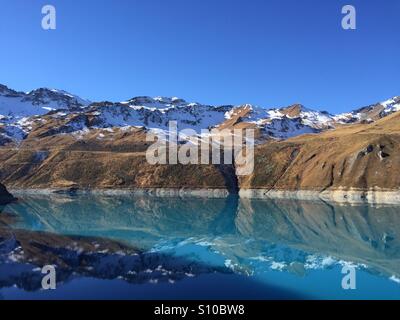 Reflection of the mountains in the Lac de Moiry, Switzerland. Stock Photo