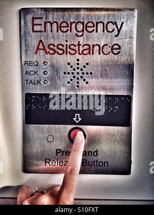 Woman hand pushing emergency button Stock Photo
