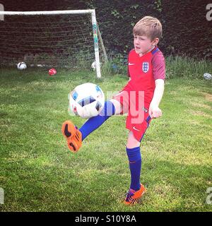 Boy in England football team away kit. France Euro 2016. Boy playing football. Stock Photo