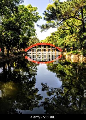 Sumiyoshi taisha, also known as Sumiyoshi Grand Shrine, is a Shinto shrine in Sumiyoshi ward in the city of Osaka, Japan. This bridge spans the river nearby Stock Photo