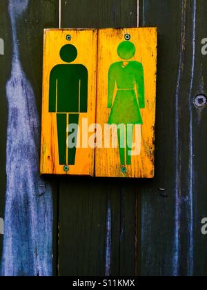 Toilet for all. Simple, old fashioned, classic washroom. Pictogram sign. No words. Painted. Public bathroom. No Braille. Not high-tech. Stock Photo