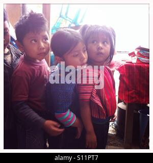 Maya indigenous children wait in a line at preschool in San Antonio Palopo, Solola, Guatemala. Stock Photo