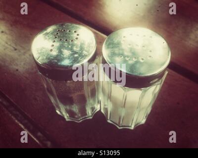 Salt and pepper shakers on a wooden surface, retro style Stock Photo