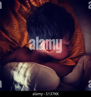 sleeping boy in his bed Stock Photo