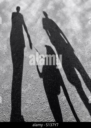 Shadows of man walking dog with leash Stock Photo - Alamy