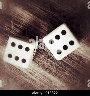 Two dices on a wooden table Stock Photo