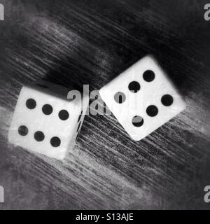 Two dices on a wooden table Stock Photo