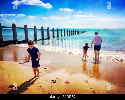 A family playing on the beach at Dawlish Warren in Devon, UK. Stock Photo