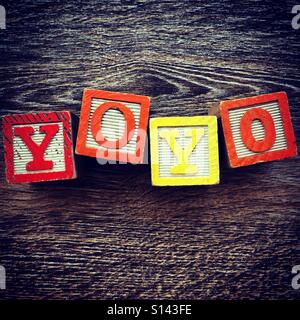 YOYO word written with wood block letter toys Stock Photo