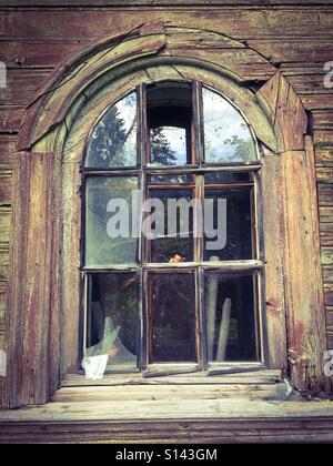 The window with broken glass in a wooden old house Stock Photo