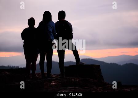 Group of backpackers at the view deck of Mines View Park, Baguio City, Philippines enjoying the sunrise. Stock Photo
