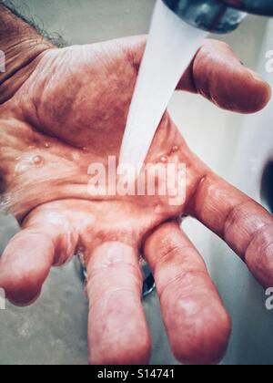 Water in hand. Stock Photo