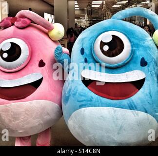 Two Blue & Pink Costumed Alien Beings Invade The Earth With Hearts & Love, Men Are From Mars, Women Are From Venus Stock Photo