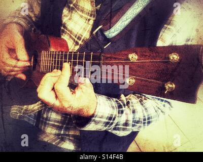 Woman playing ukulele Stock Photo