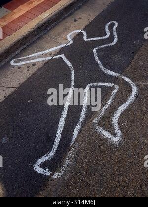 Painted outline of a person's body on city street Stock Photo